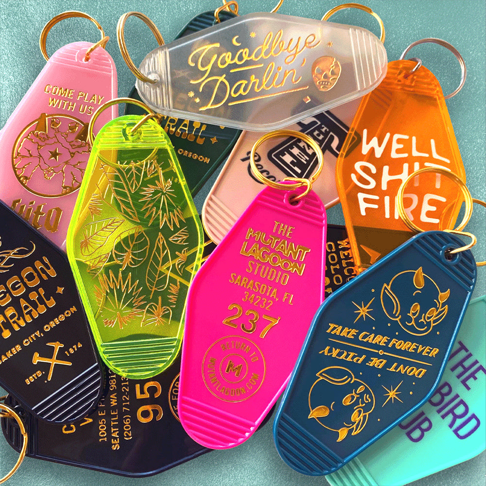 Colorful custom motel-style keychains with retro designs in foil embossed, UV printed and patch styles