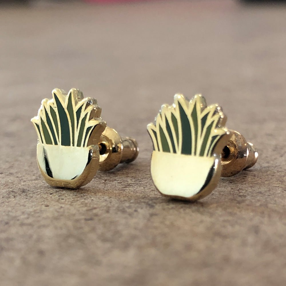 Custom enamel earrings with detailed character designs in hard and soft enamel finishes